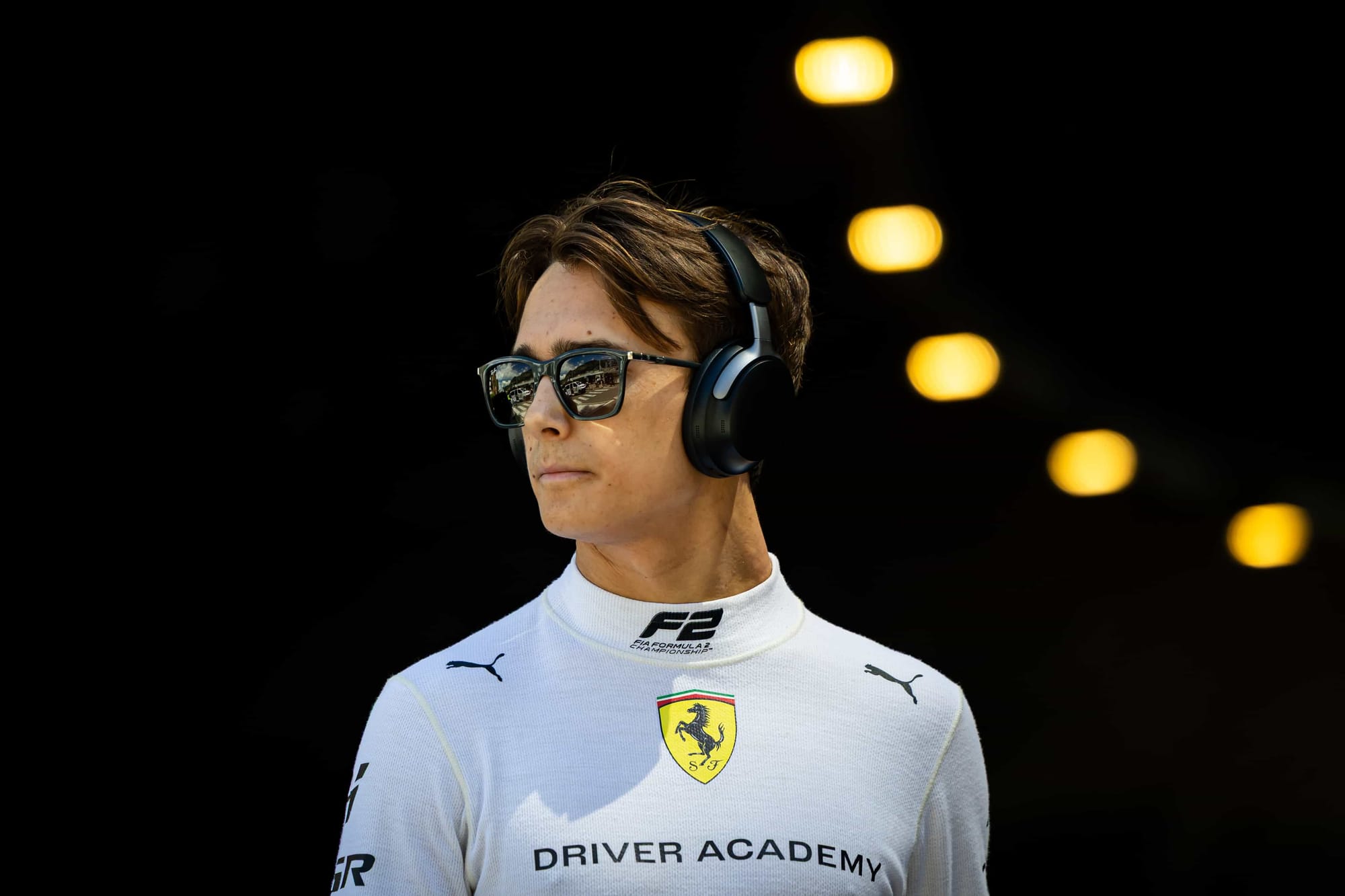 F2 driver Dino Beganovic getting ready for a Formula 2 race in his Ferrari Driver Academy uniform