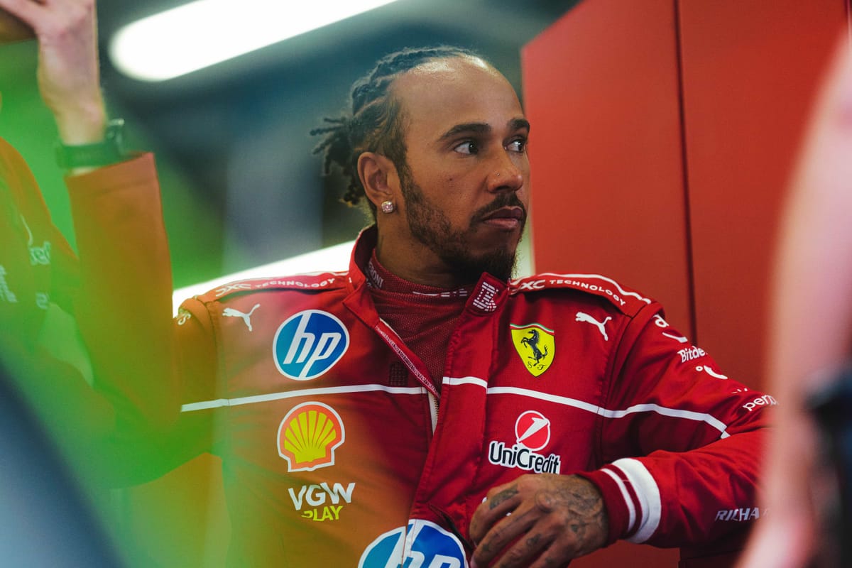 Lewis Hamilton standing in the Ferrari F1 paddock 